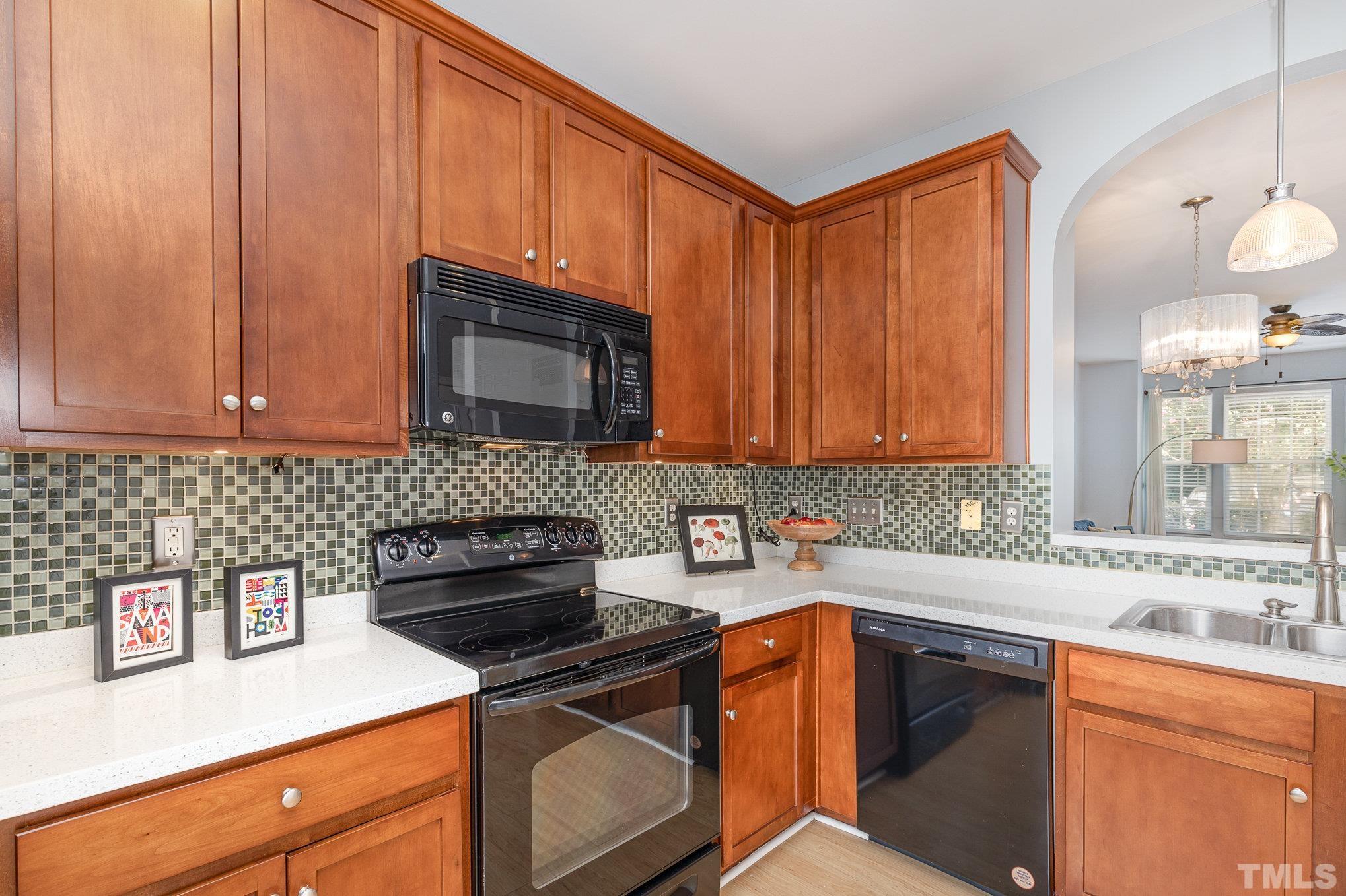 800 Bryant Street Raleigh, NC 27603 - Photo 7 of 20 a kitchen with stainless steel appliances a stove a sink and cabinets
