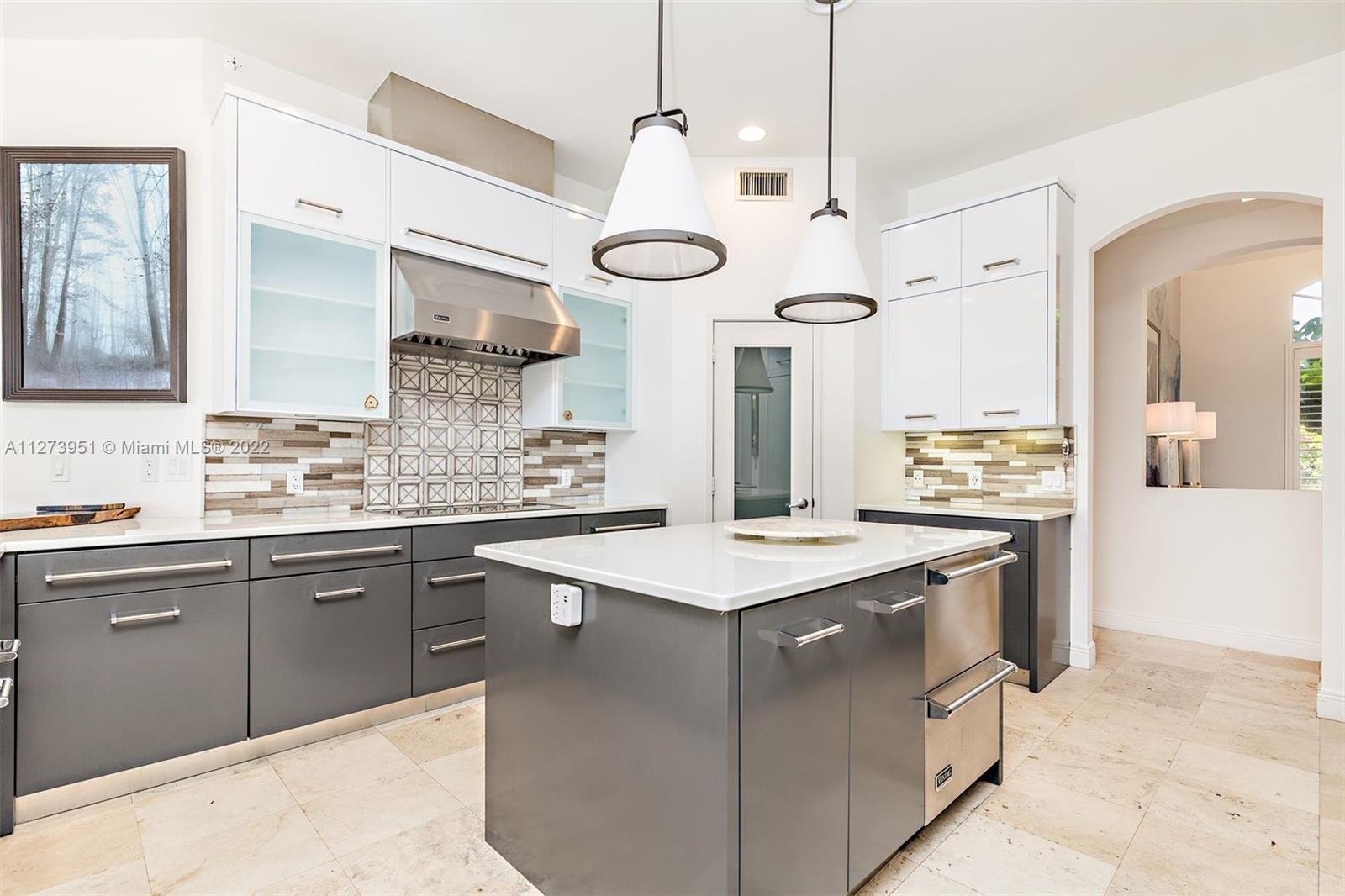 9460 Southeast Point Terrace Jupiter, FL 33469 - Photo 13 of 51 a kitchen with stainless steel appliances granite countertop a sink a stove and a wooden floors