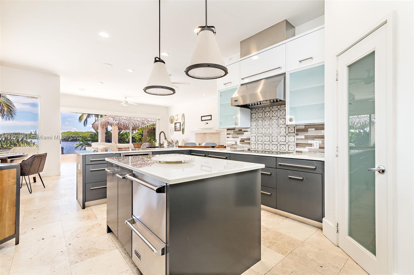 9460 Southeast Point Terrace Jupiter, FL 33469 - Photo 15 of 51 a kitchen with stainless steel appliances granite countertop a sink and cabinets