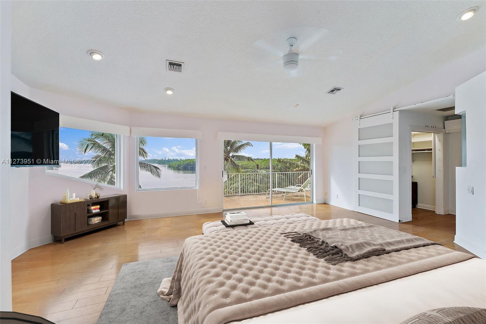 9460 Southeast Point Terrace Jupiter, FL 33469 - Photo 18 of 51 a bedroom with a bed and a television