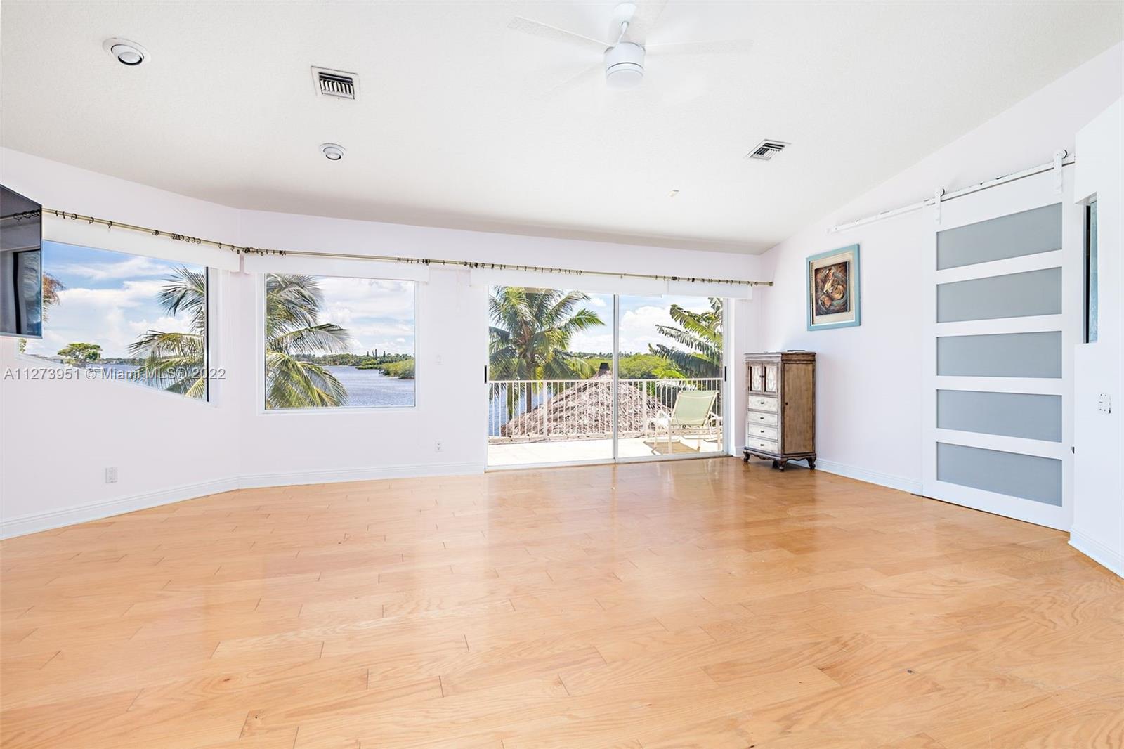 9460 Southeast Point Terrace Jupiter, FL 33469 - Photo 19 of 51 wooden floor in an empty room with a window