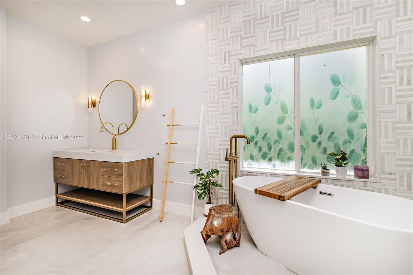 9460 Southeast Point Terrace Jupiter, FL 33469 - Photo 20 of 51 a living room with a large window and a chandelier