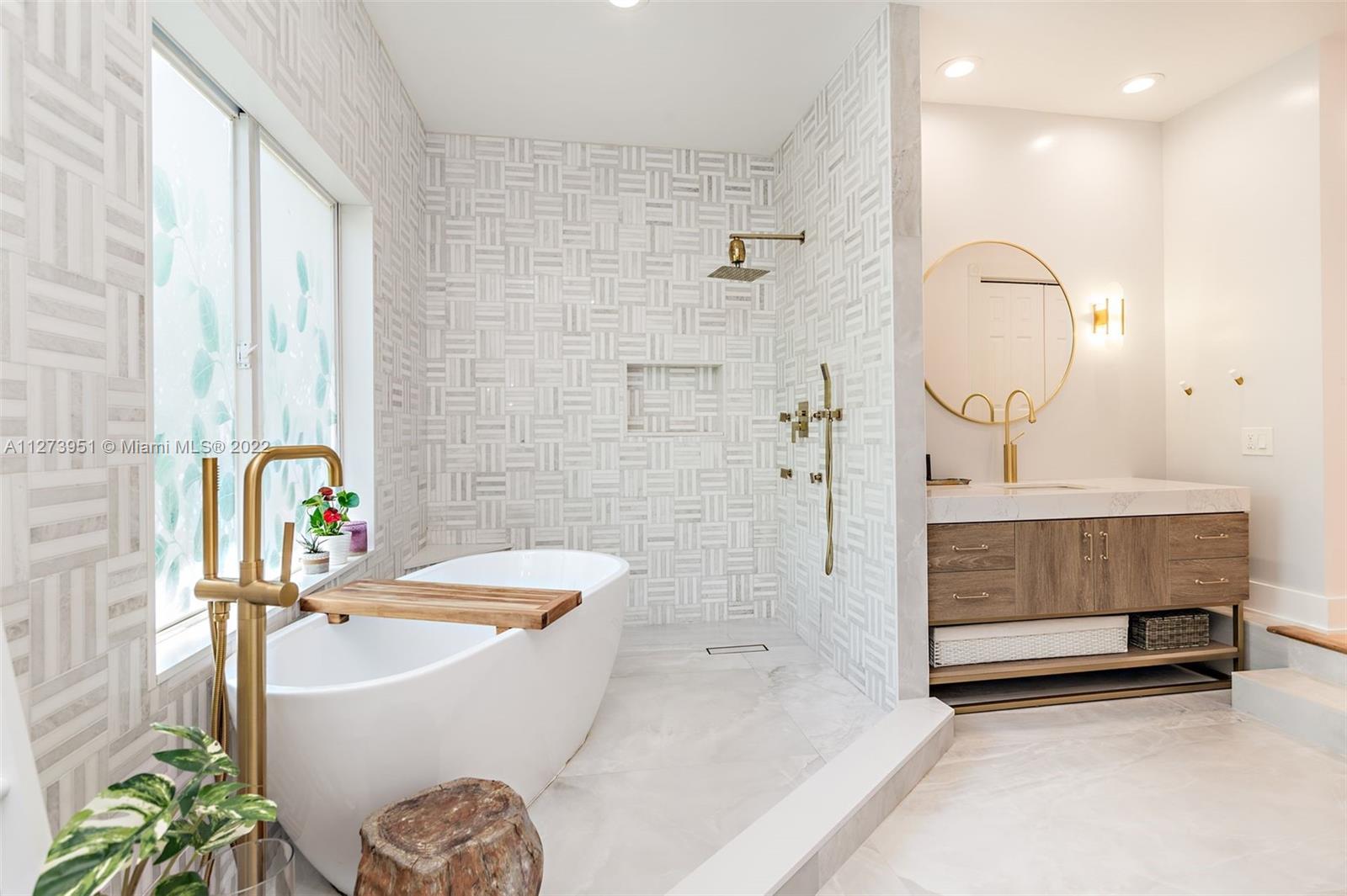 9460 Southeast Point Terrace Jupiter, FL 33469 - Photo 21 of 51 a bathroom with a sink a bathtub and a shower