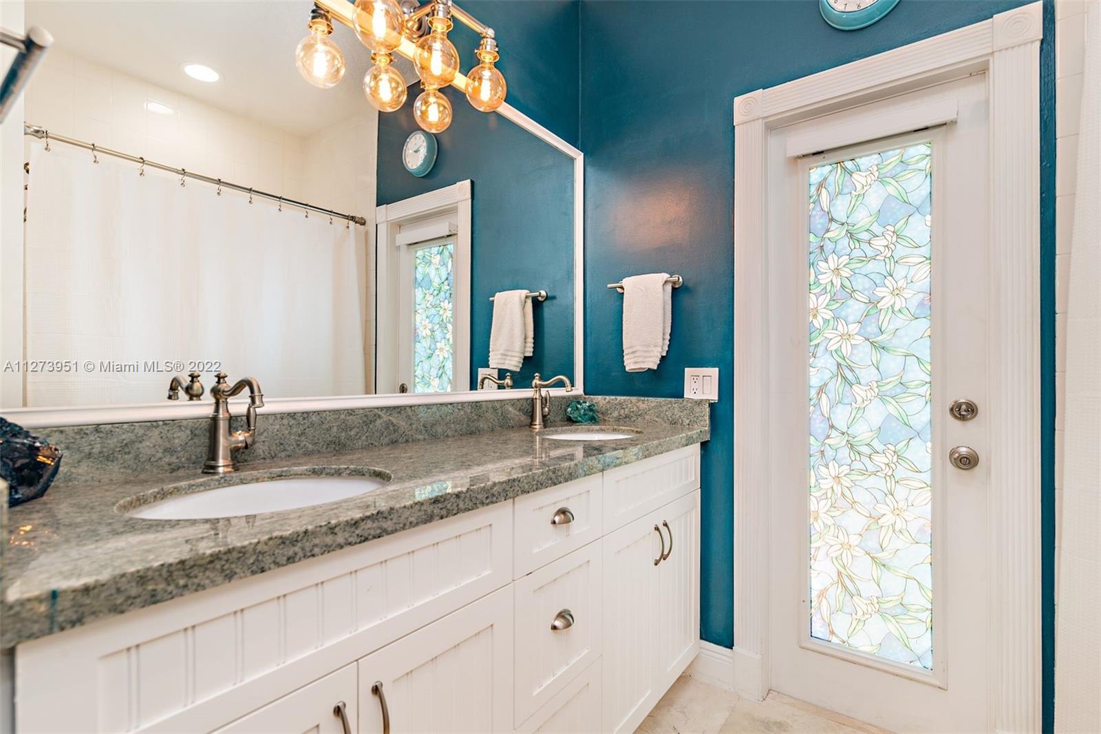 9460 Southeast Point Terrace Jupiter, FL 33469 - Photo 25 of 51 a bathroom with a granite countertop sink and a mirror