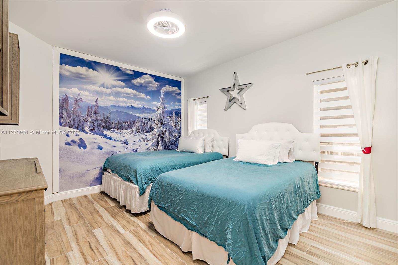 9460 Southeast Point Terrace Jupiter, FL 33469 - Photo 26 of 51 a bedroom with a bed and a painting on the wall