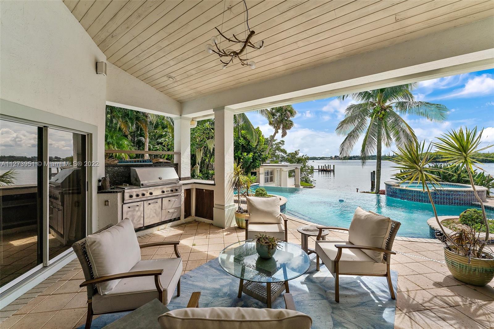 9460 Southeast Point Terrace Jupiter, FL 33469 - Photo 33 of 51 a living room with furniture and a floor to ceiling window