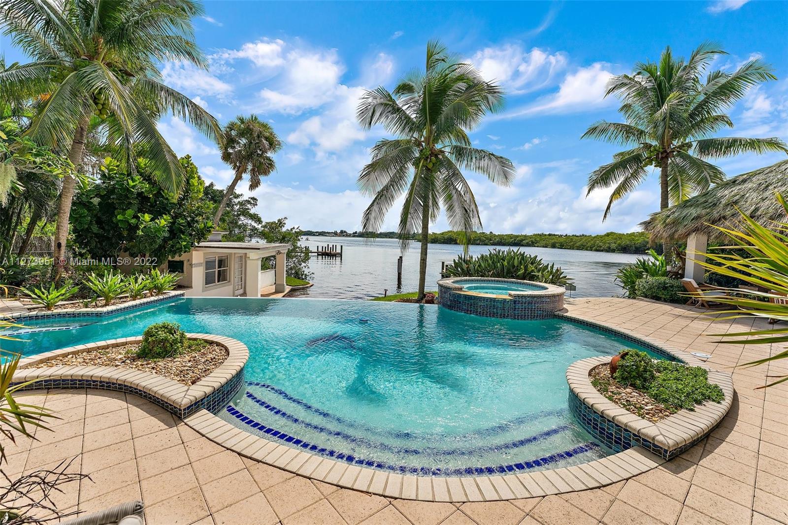 9460 Southeast Point Terrace Jupiter, FL 33469 - Photo 34 of 51 a view of a swimming pool with a patio