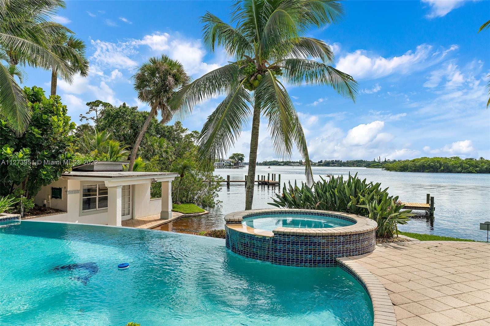9460 Southeast Point Terrace Jupiter, FL 33469 - Photo 35 of 51 a view of a house with swimming pool and a yard