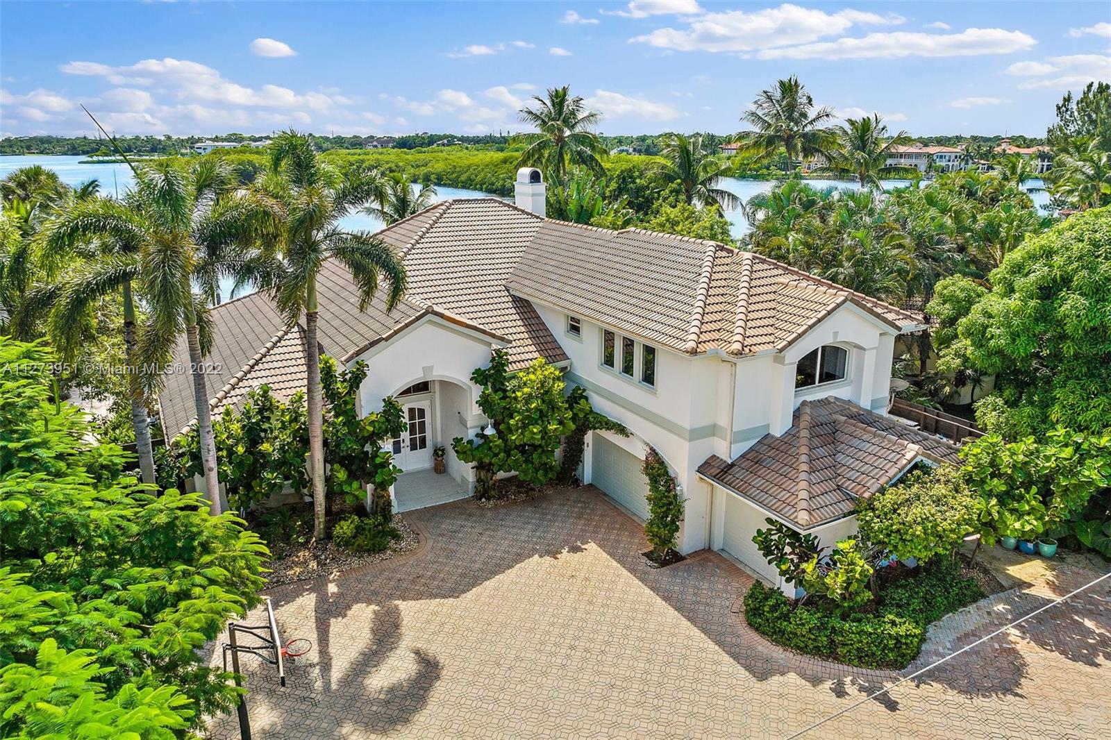 9460 Southeast Point Terrace Jupiter, FL 33469 - Photo 43 of 51 a aerial view of a house with a yard and potted plants