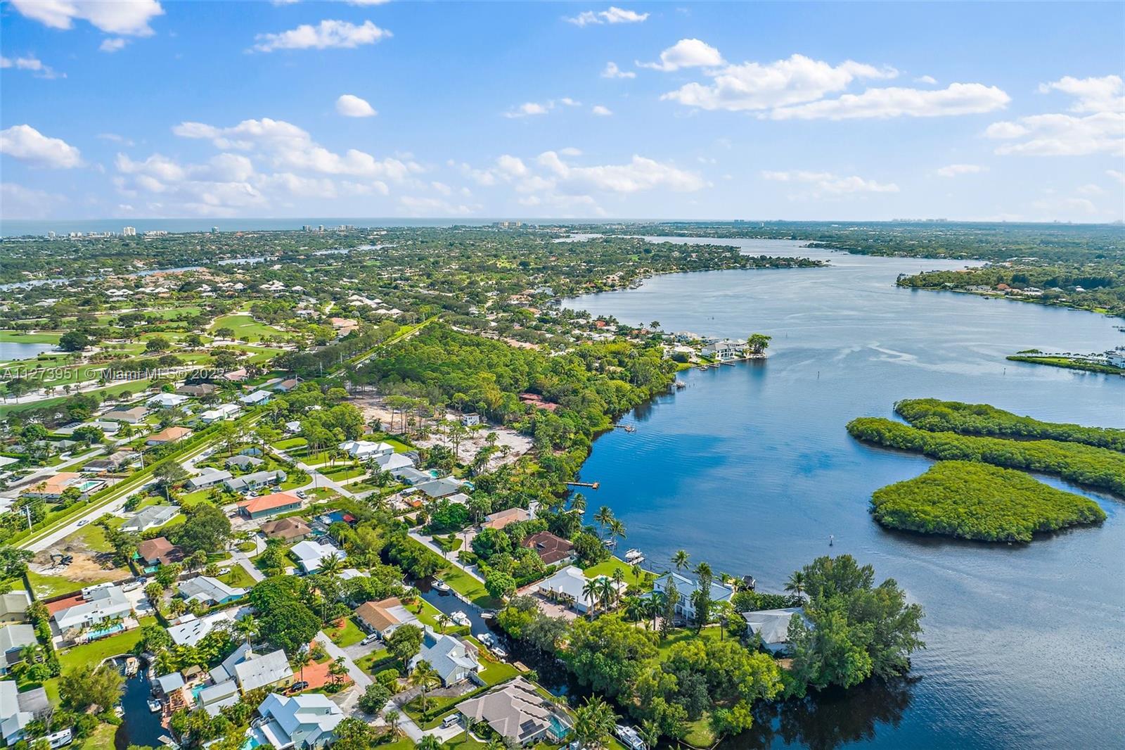 9460 Southeast Point Terrace Jupiter, FL 33469 - Photo 46 of 51 a view of a lake with a building in front of it