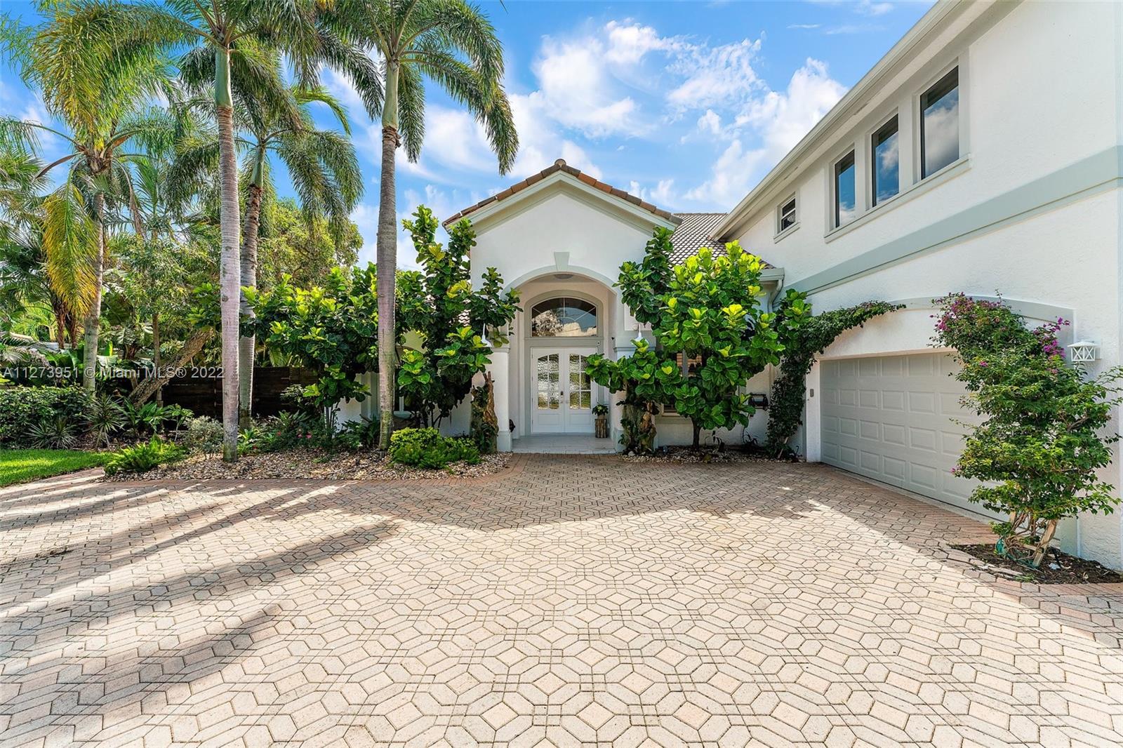 9460 Southeast Point Terrace Jupiter, FL 33469 - Photo 6 of 51 a view of a house with a yard and potted plants