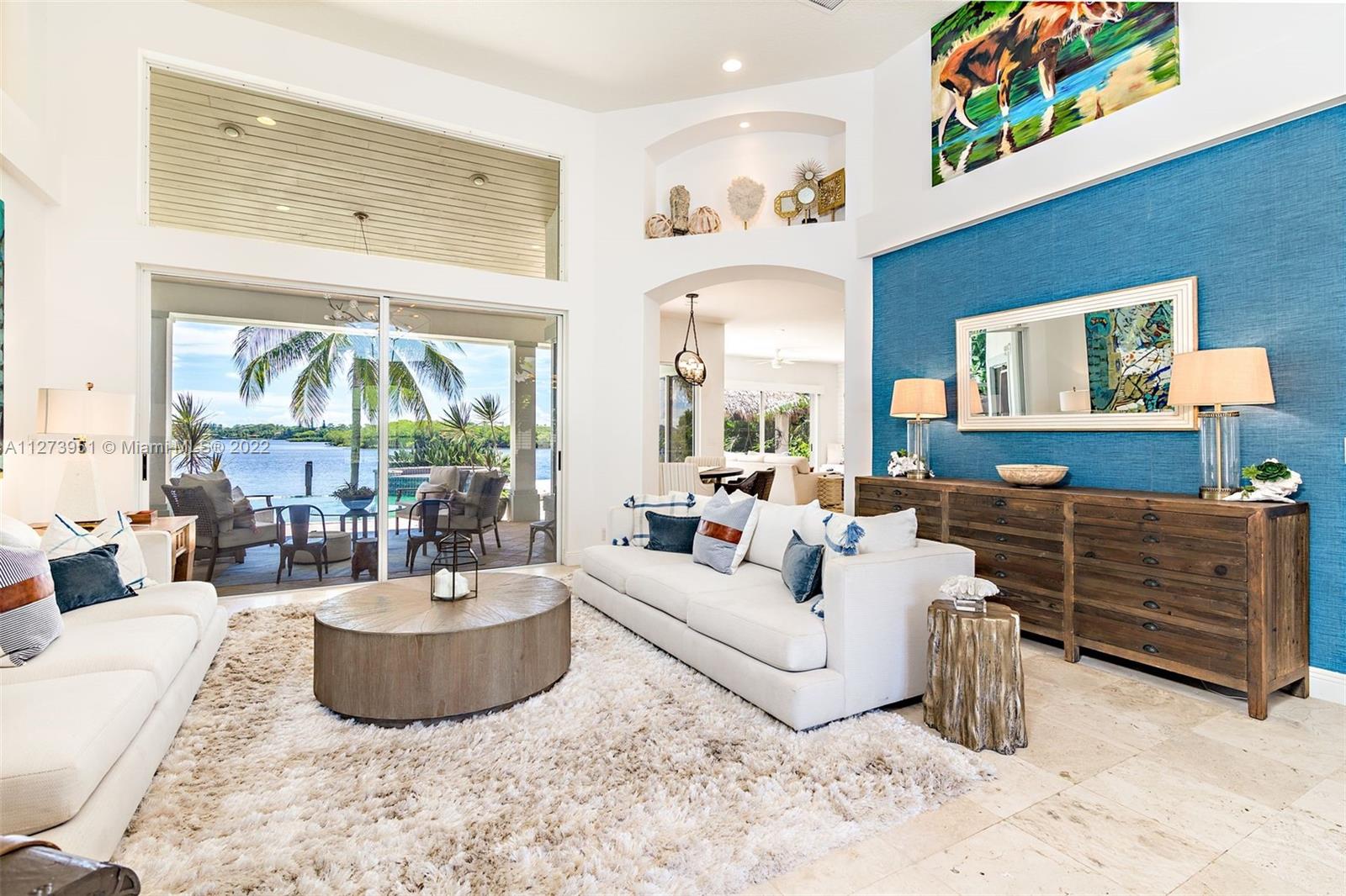 9460 Southeast Point Terrace Jupiter, FL 33469 - Photo 7 of 51 a living room with furniture and a large window