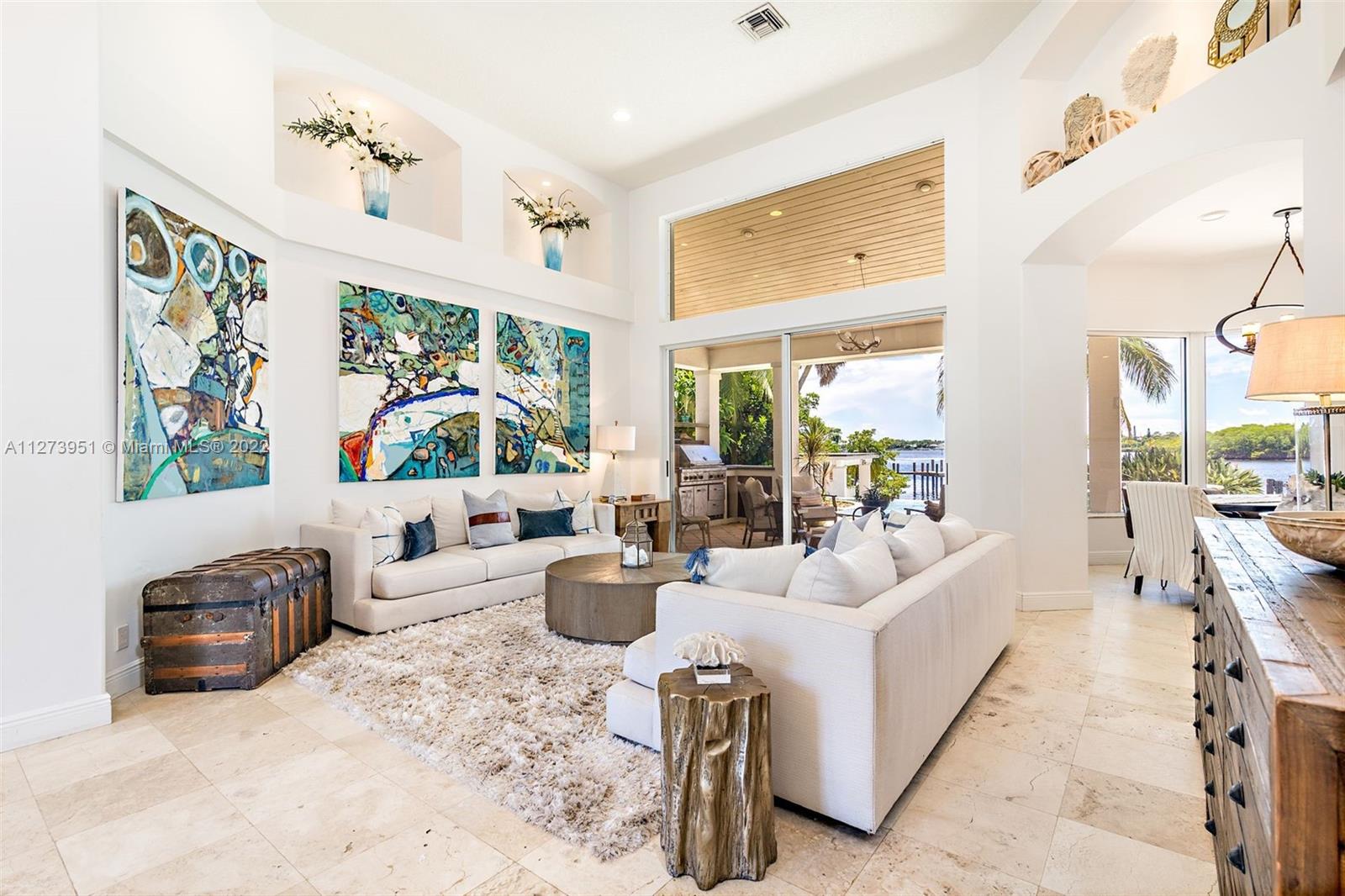 9460 Southeast Point Terrace Jupiter, FL 33469 - Photo 8 of 51 a living room with furniture large window and flat screen tv