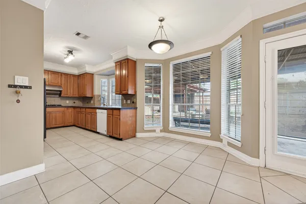 a open kitchen with stainless steel appliances granite countertop a refrigerator and a sink