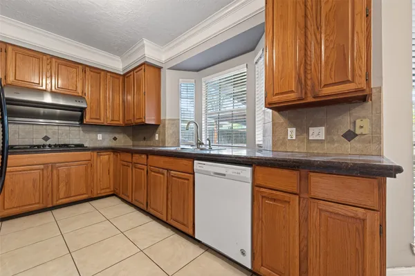 a kitchen with stainless steel appliances granite countertop a sink and cabinets