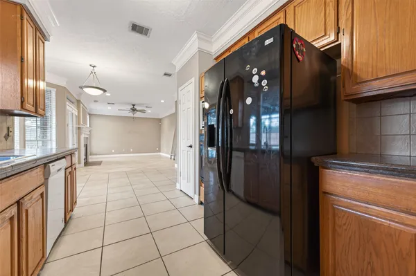 a kitchen with stainless steel appliances granite countertop a refrigerator and a stove