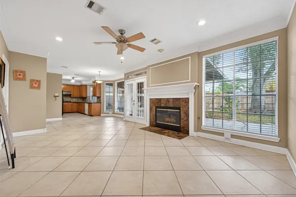a view of an empty room with a fireplace and a window
