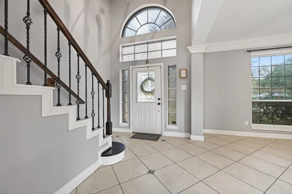 a view of an entryway with wooden floor and windows