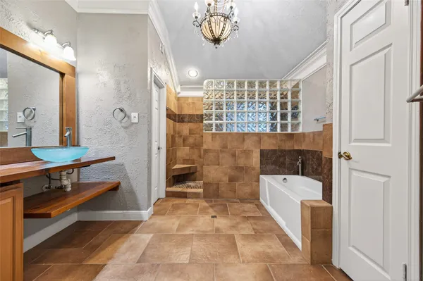 a bathroom with a tub a sink and a shower