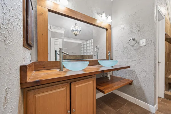 a view of bathroom with a sink and mirror