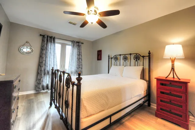 a bedroom with a bed and a chandelier