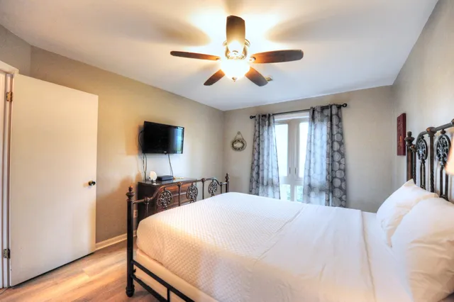 a bedroom with a bed and a flat screen tv