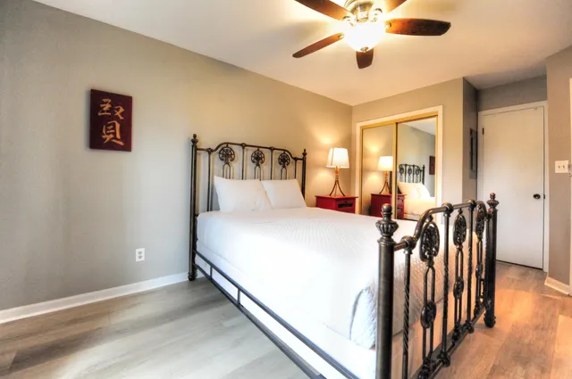 a bed room with a bed and a chandelier