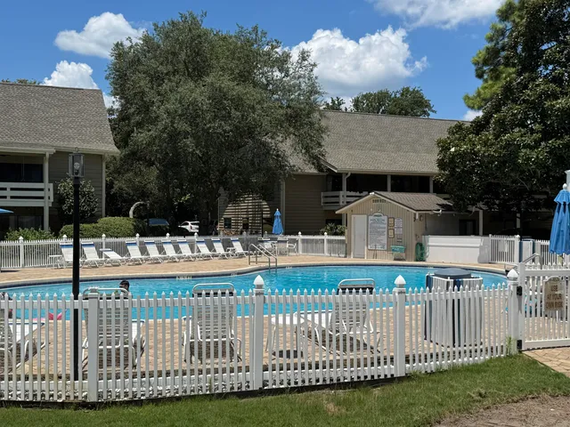 a view of a house with wooden fence