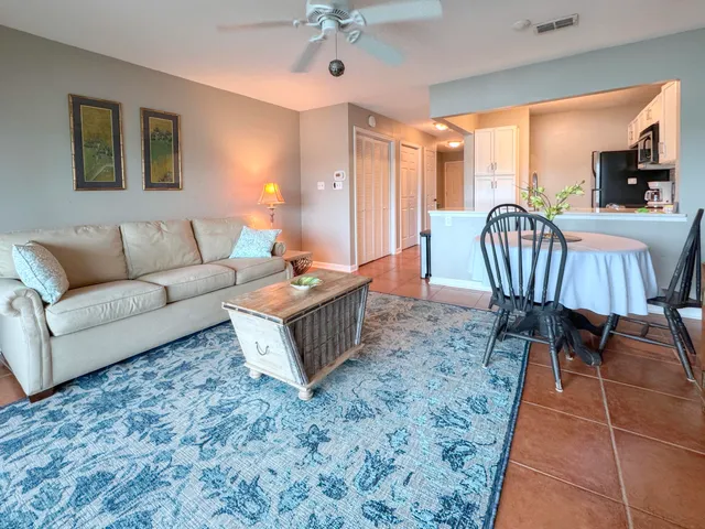 a living room with furniture a dining table and a bookshelf