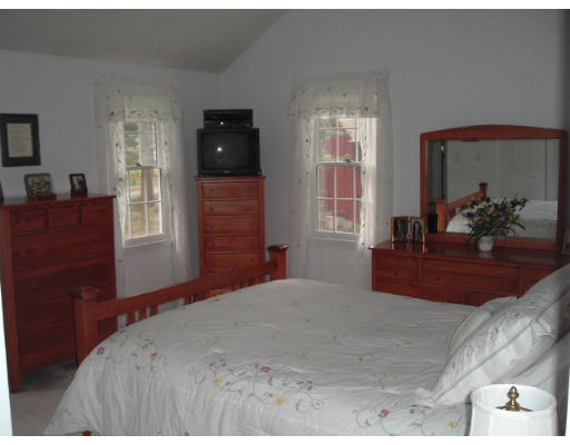 24 Old Stow Road Hudson, MA 01749 - Photo 12 of 15 a bedroom with a bed and wooden floor