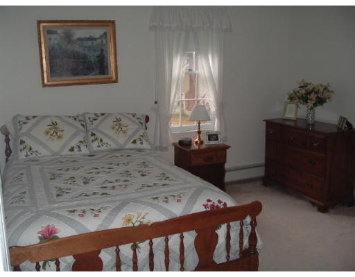 24 Old Stow Road Hudson, MA 01749 - Photo 13 of 15 a bed sitting in a bedroom next to a window with a dresser