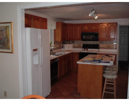 24 Old Stow Road Hudson, MA 01749 - Photo 5 of 15 a kitchen with stainless steel appliances granite countertop a refrigerator stove a sink dishwasher and microwave with wooden cabinet