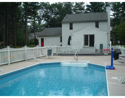 24 Old Stow Road Hudson, MA 01749 - Photo 10 of 15 a view of pool with two chairs and a yard
