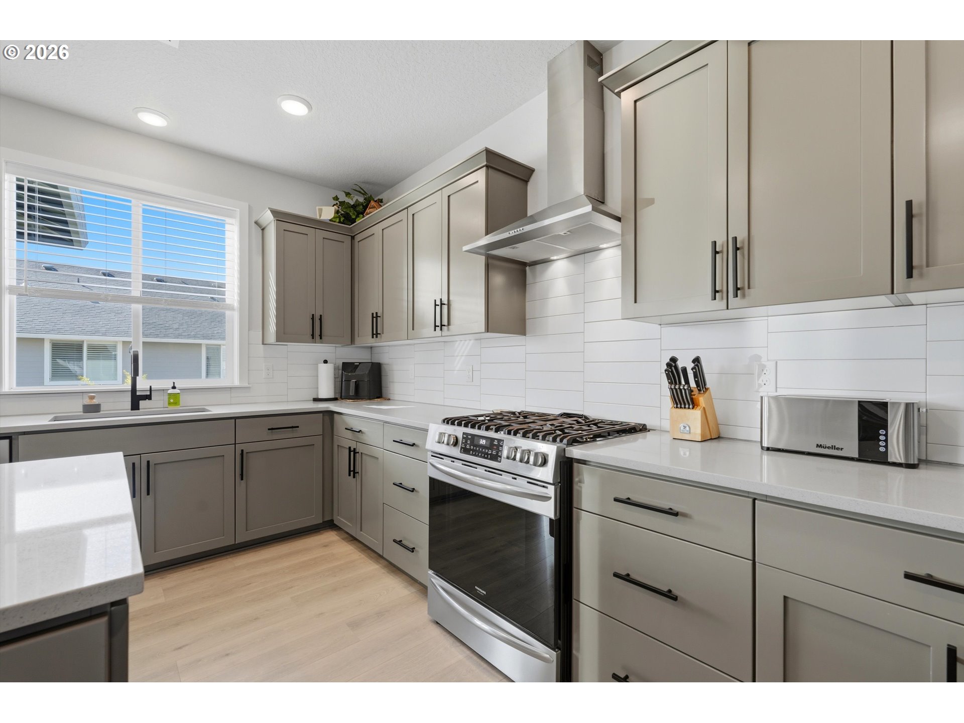 14589 Southwest Jensen Terrace Portland, OR 97224 - Photo 16 of 42 a kitchen with granite countertop cabinets stainless steel appliances and a sink