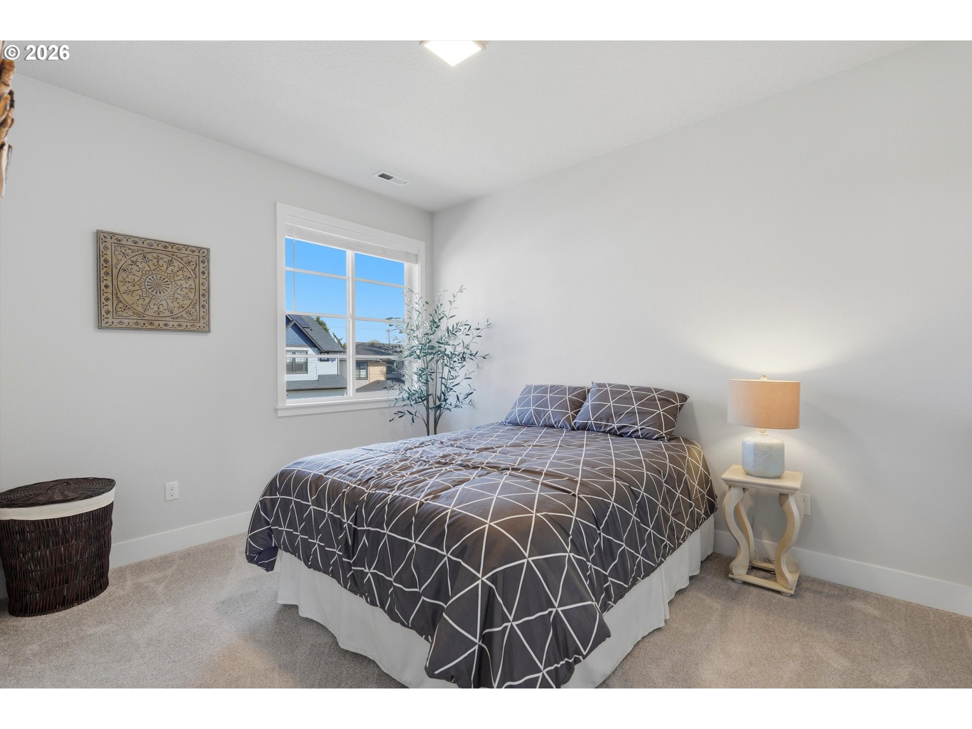 14589 Southwest Jensen Terrace Portland, OR 97224 - Photo 23 of 42 a bedroom with a bed and a night stand