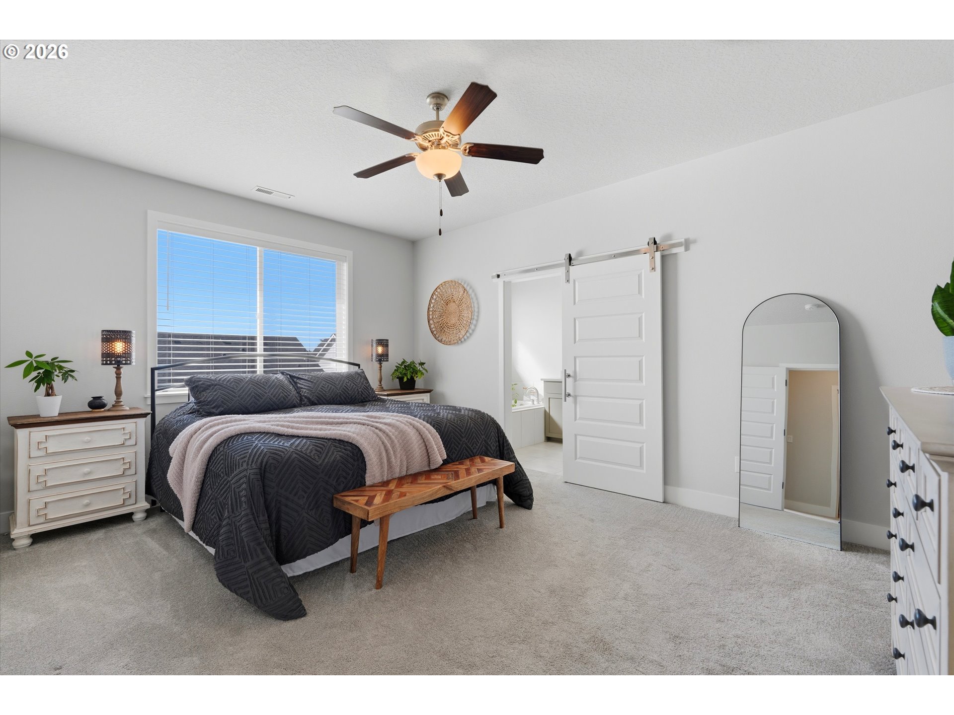 14589 Southwest Jensen Terrace Portland, OR 97224 - Photo 24 of 42 a spacious bedroom with a bed a window and potted plant