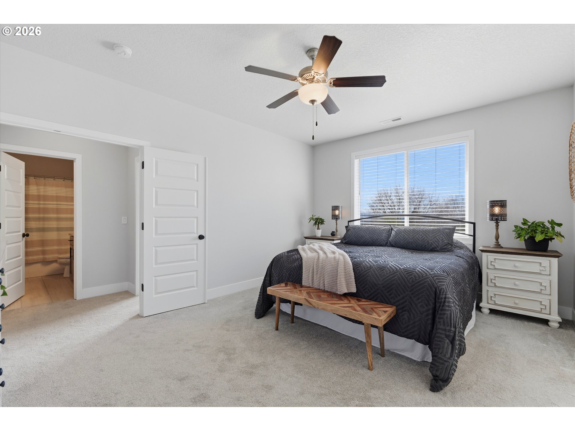 14589 Southwest Jensen Terrace Portland, OR 97224 - Photo 26 of 42 a bed room with a bed and a ceiling fan