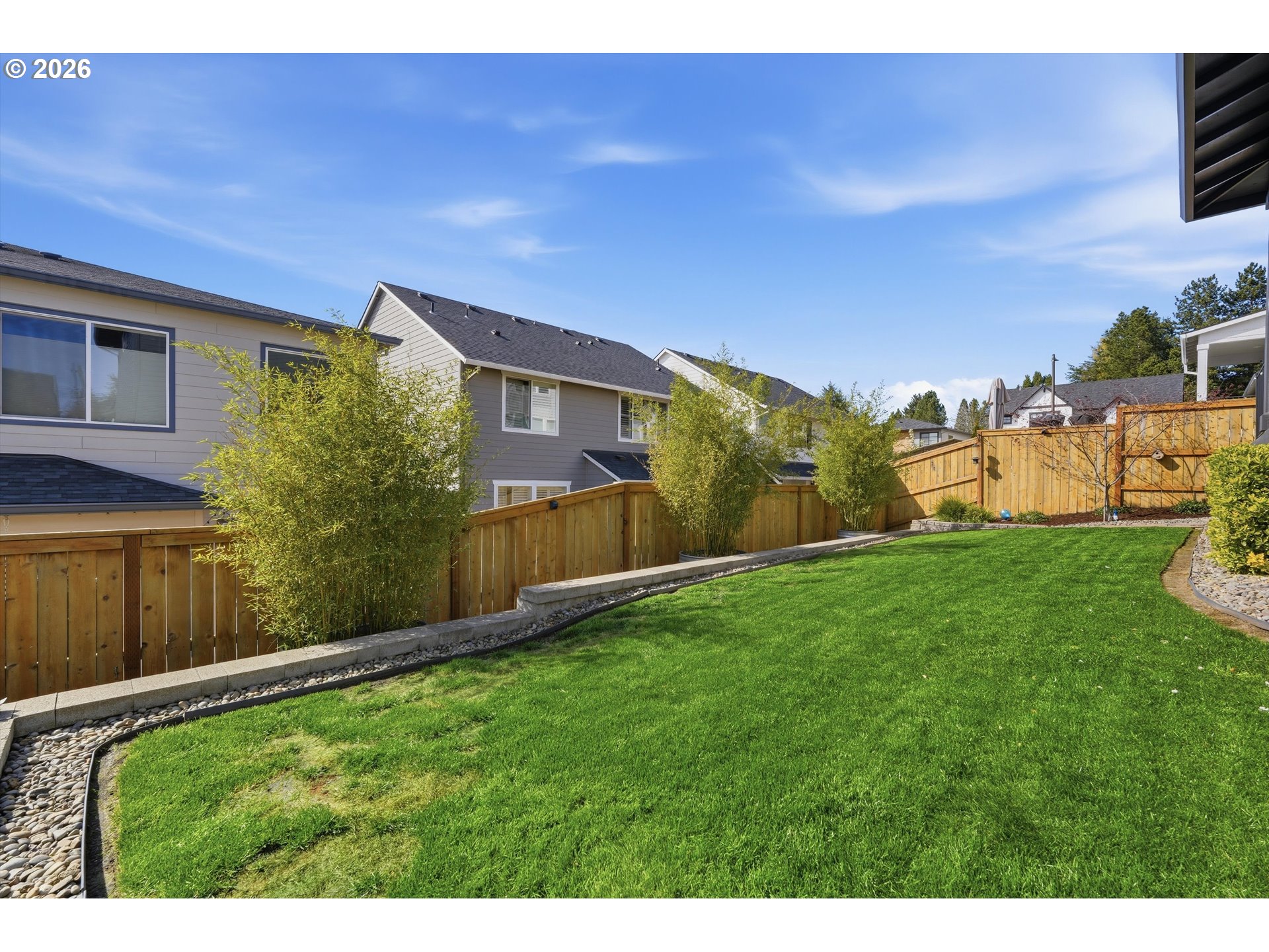 14589 Southwest Jensen Terrace Portland, OR 97224 - Photo 39 of 42 a view of a backyard with plants and a large tree