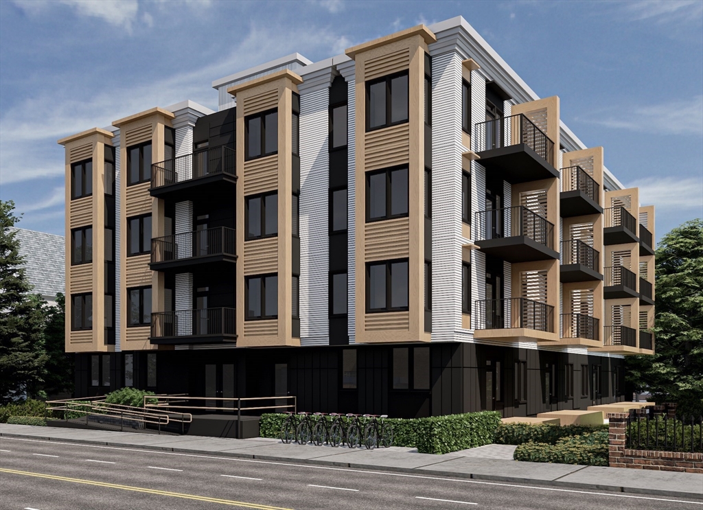 84 Prospect Street, Unit 104 Somerville, MA 02143 - Photo 1 of 7 a front view of a building with a yard