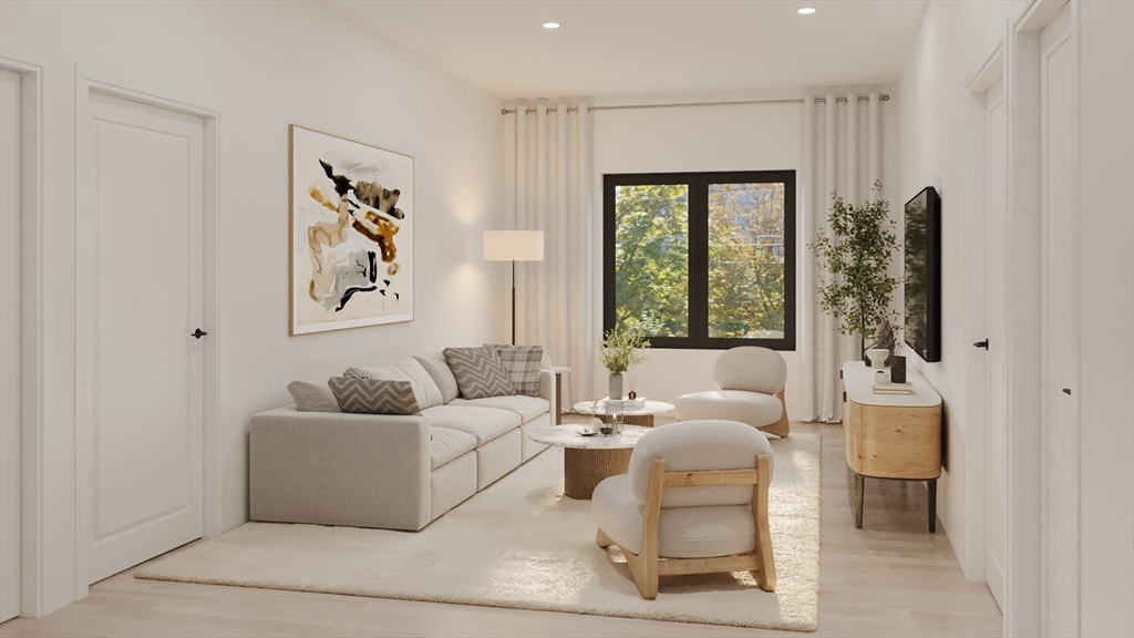 84 Prospect Street, Unit 104 Somerville, MA 02143 - Photo 3 of 7 a living room with furniture and a large window