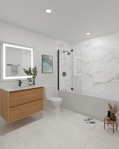 a bathroom with a sink a toilet and shower