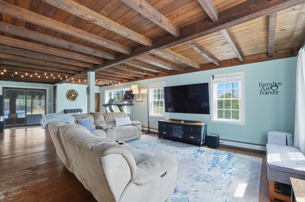 61 Main Street Hanover, MA 02339 - Photo 6 of 38 a living room with furniture and a flat screen tv