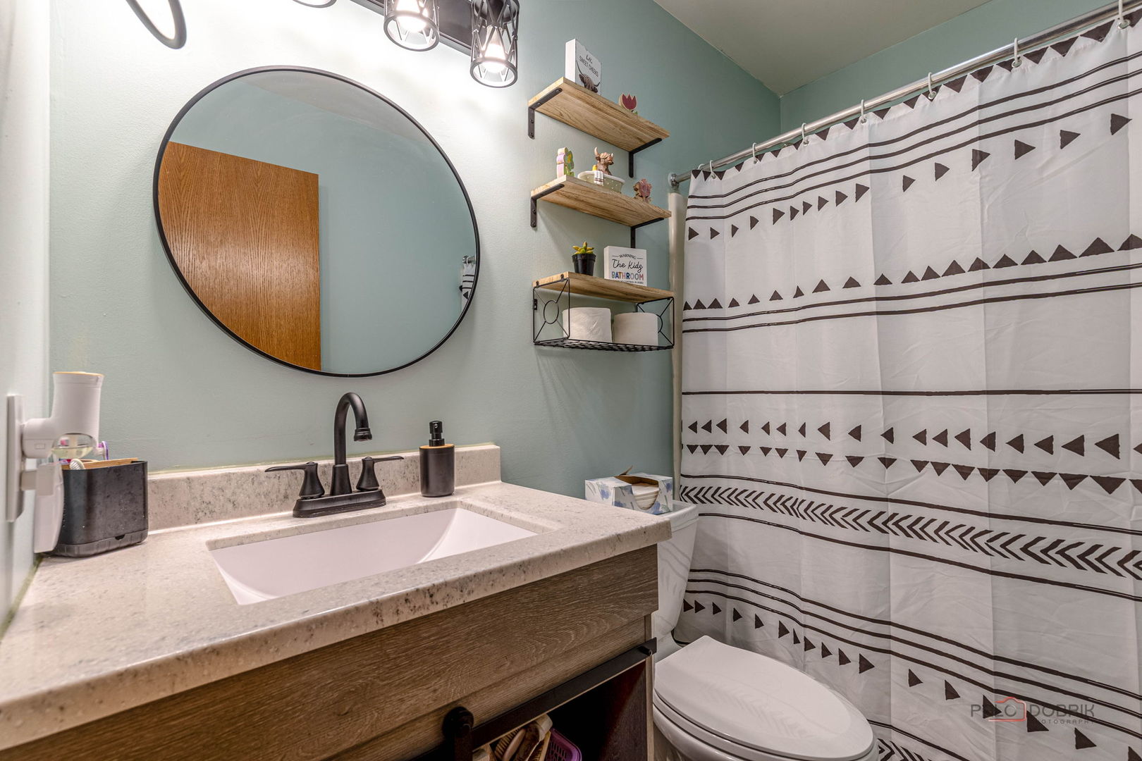 807 Aspen Way Genoa, IL 60135 - Photo 12 of 29 a bathroom with a sink a toilet and a mirror