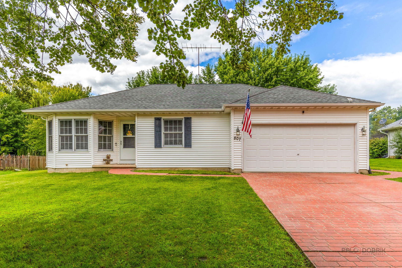 807 Aspen Way Genoa, IL 60135 - Photo 2 of 29 a front view of a house with a yard and garage