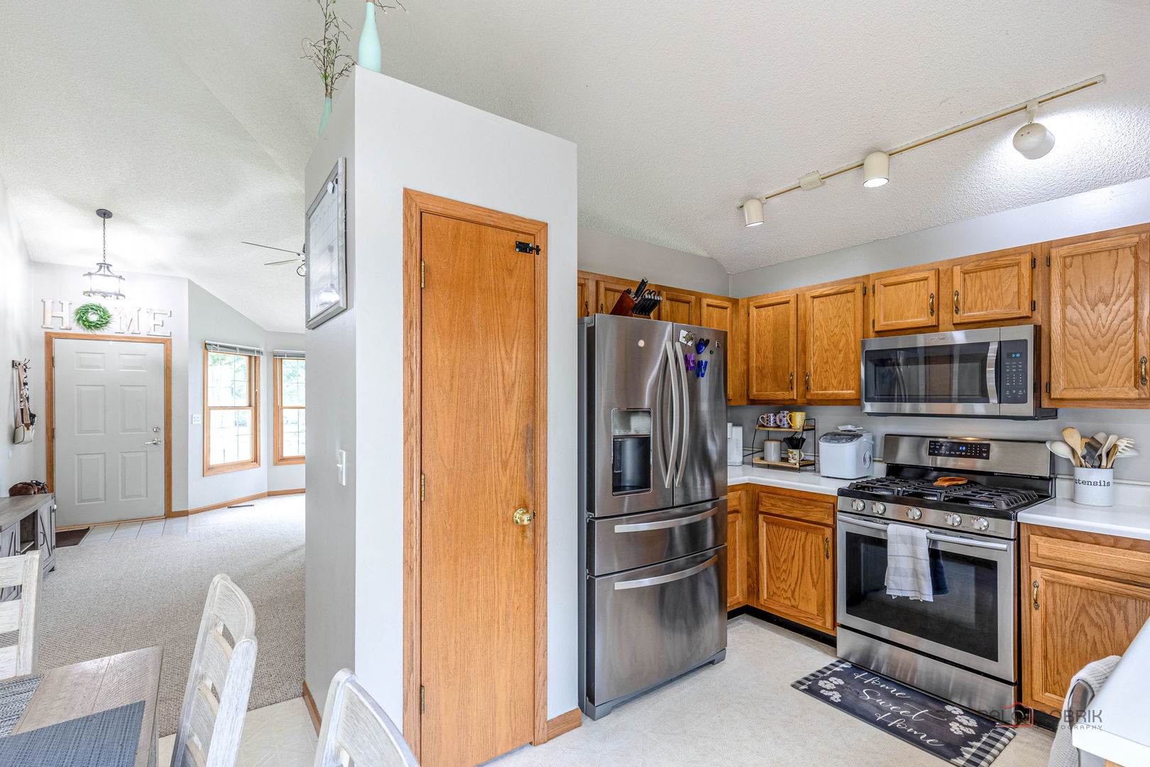 807 Aspen Way Genoa, IL 60135 - Photo 6 of 29 a kitchen with stainless steel appliances a stove a refrigerator a sink a stove and cabinets