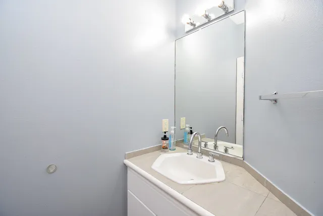 a bathroom with a sink and a mirror