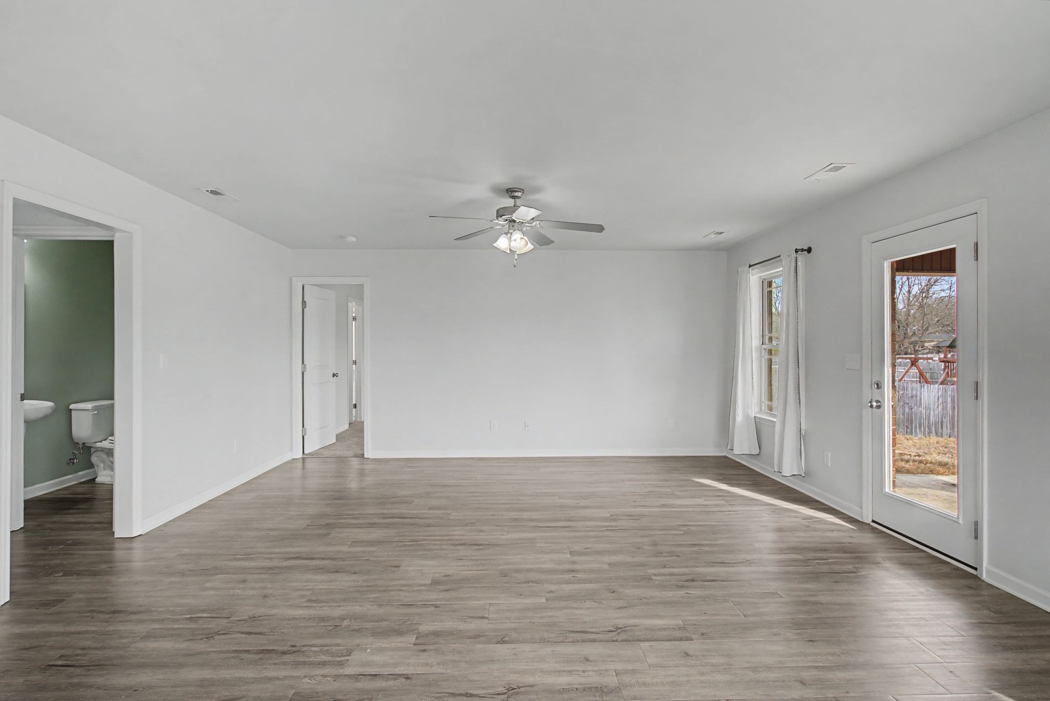 225 Masters Way Fayetteville, TN 37334 - Photo 11 of 31 a view of an empty room with wooden floor and a ceiling fan