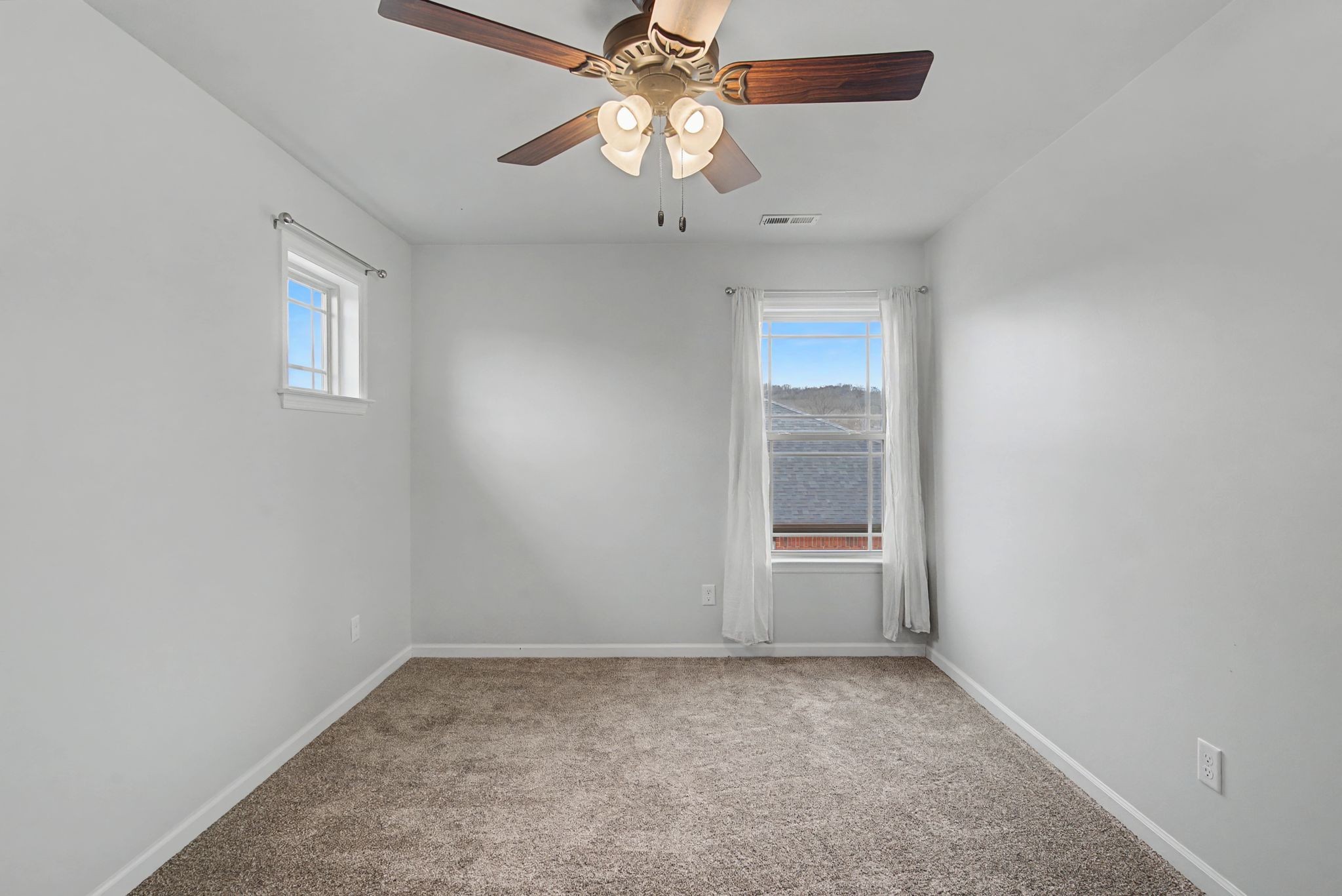 225 Masters Way Fayetteville, TN 37334 - Photo 23 of 31 an empty room with a chandelier fan and windows
