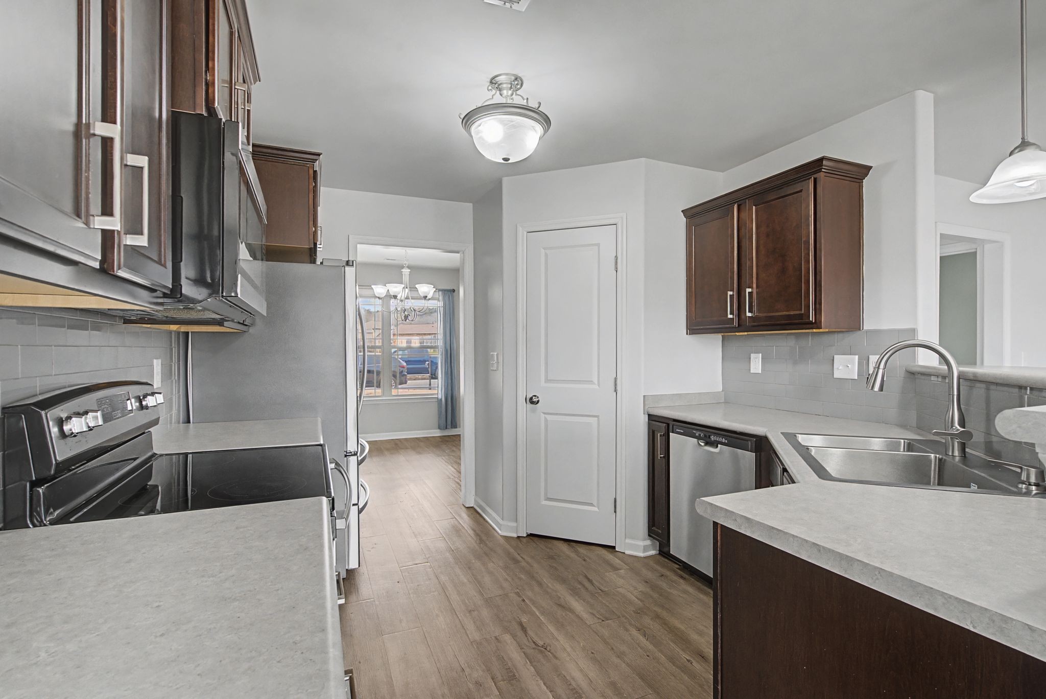 225 Masters Way Fayetteville, TN 37334 - Photo 6 of 31 a kitchen with stainless steel appliances granite countertop a sink stove and refrigerator