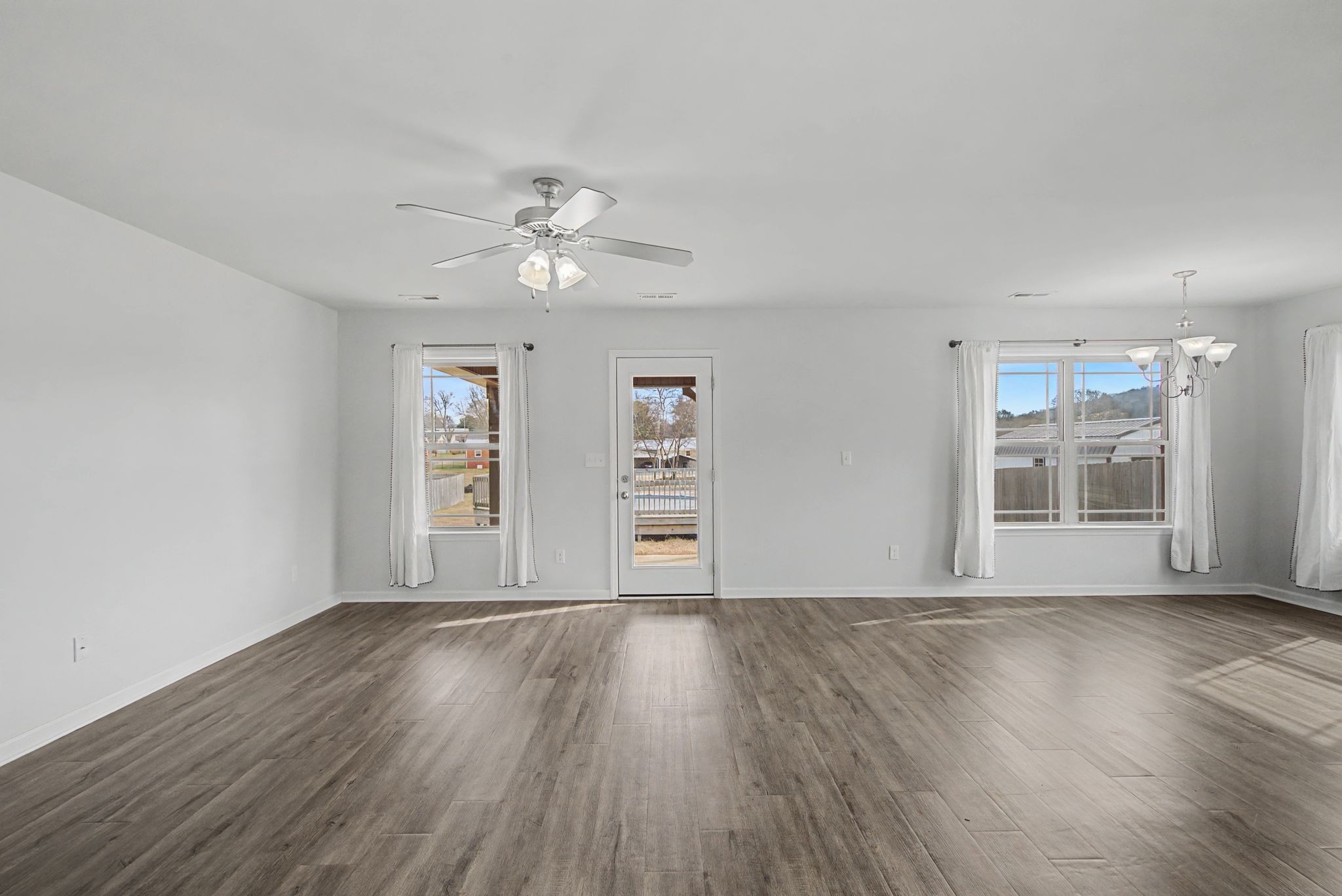225 Masters Way Fayetteville, TN 37334 - Photo 10 of 31 a view of an empty room with a window and wooden floor